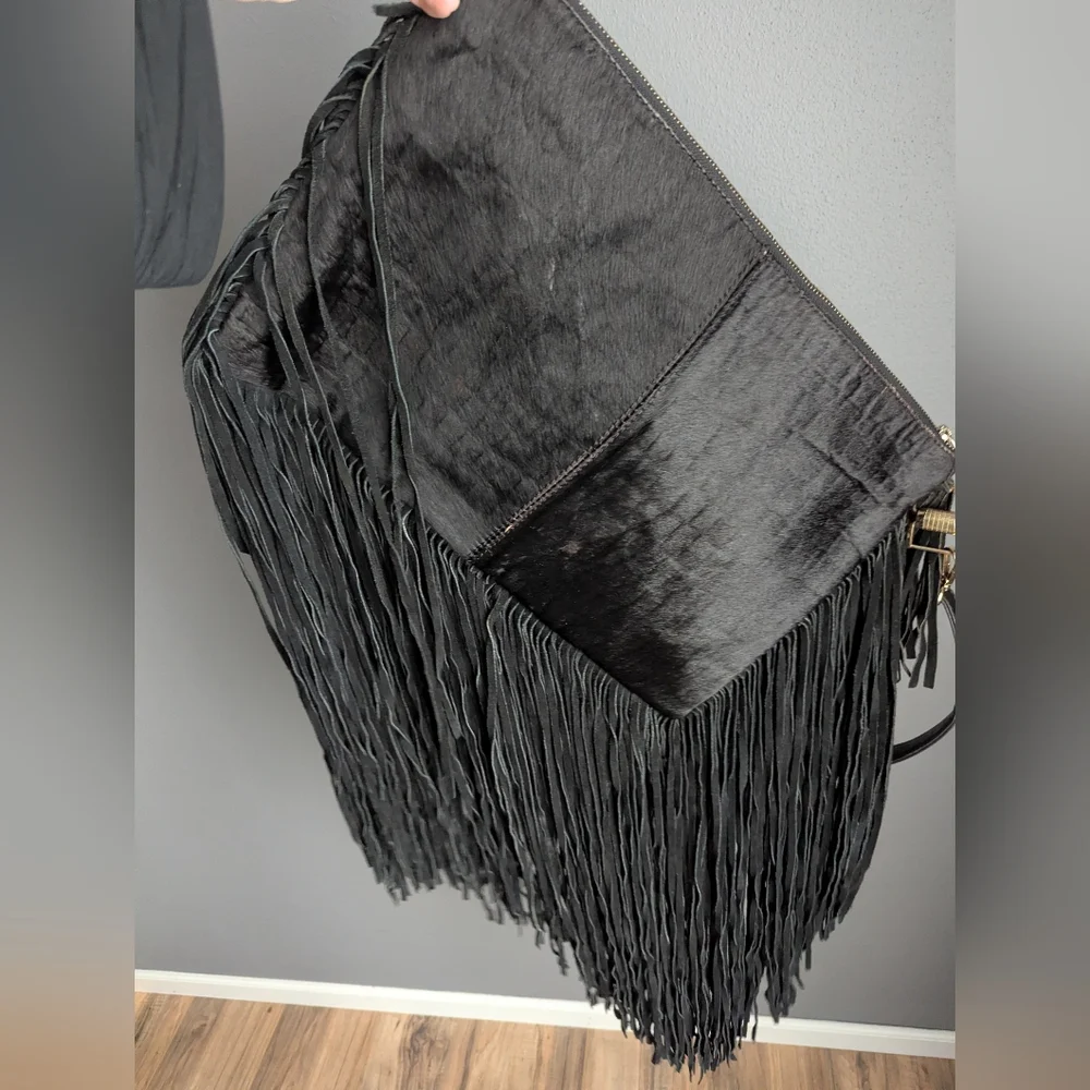 Black leather Fringe crossbody bag feels like cow leather. No tags. No brand tag